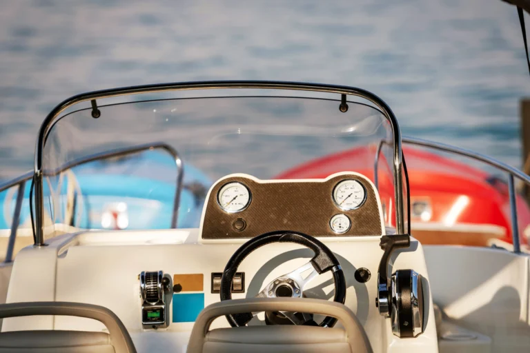 Boat Dashboard and Steering Wheel on Calm Water